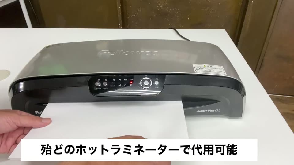 印刷したMPCシートとプラスターシートを重ねてホットラミネーターに通している様子